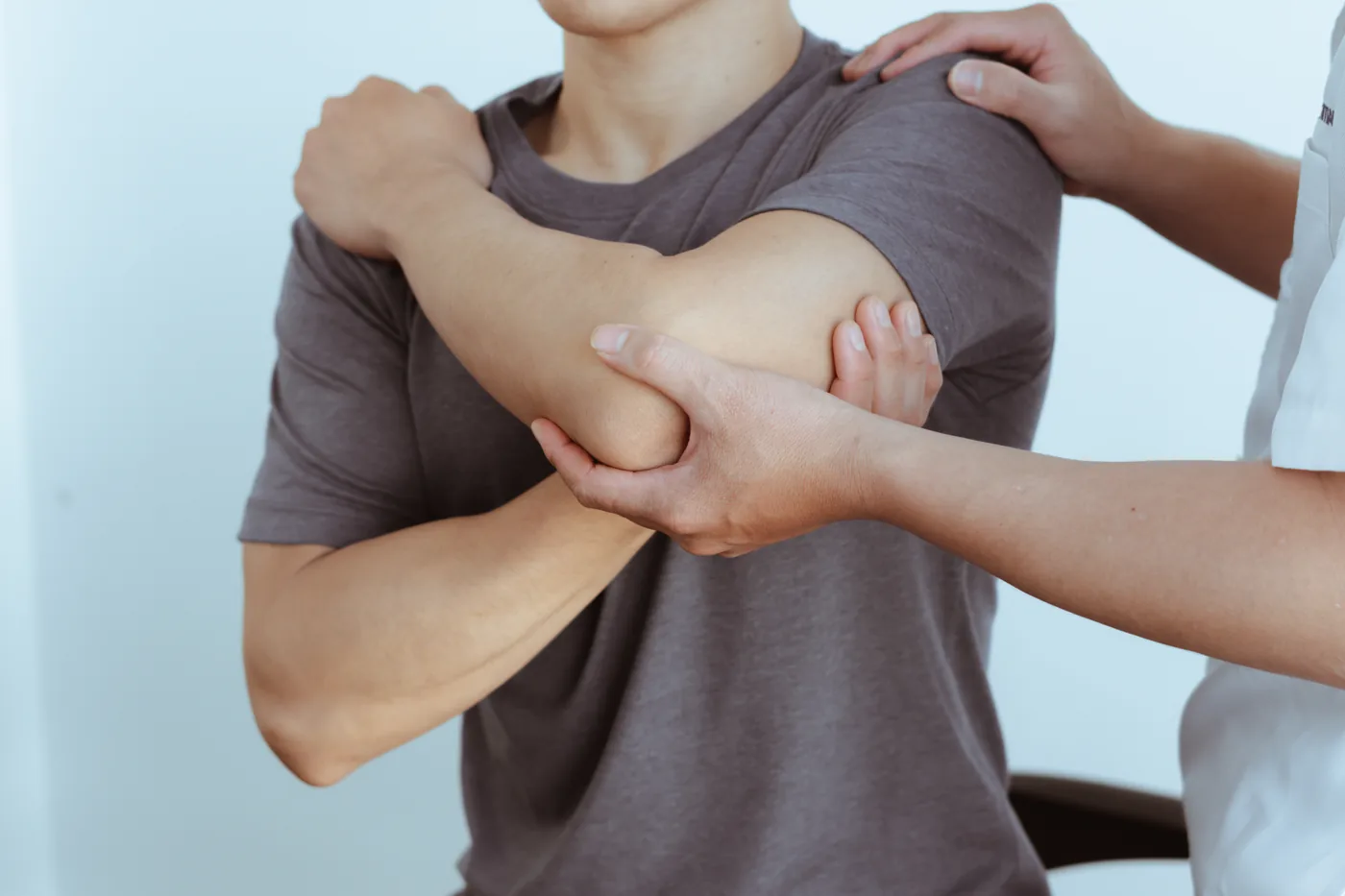 Orthopedic specialist examining a patient’s elbow