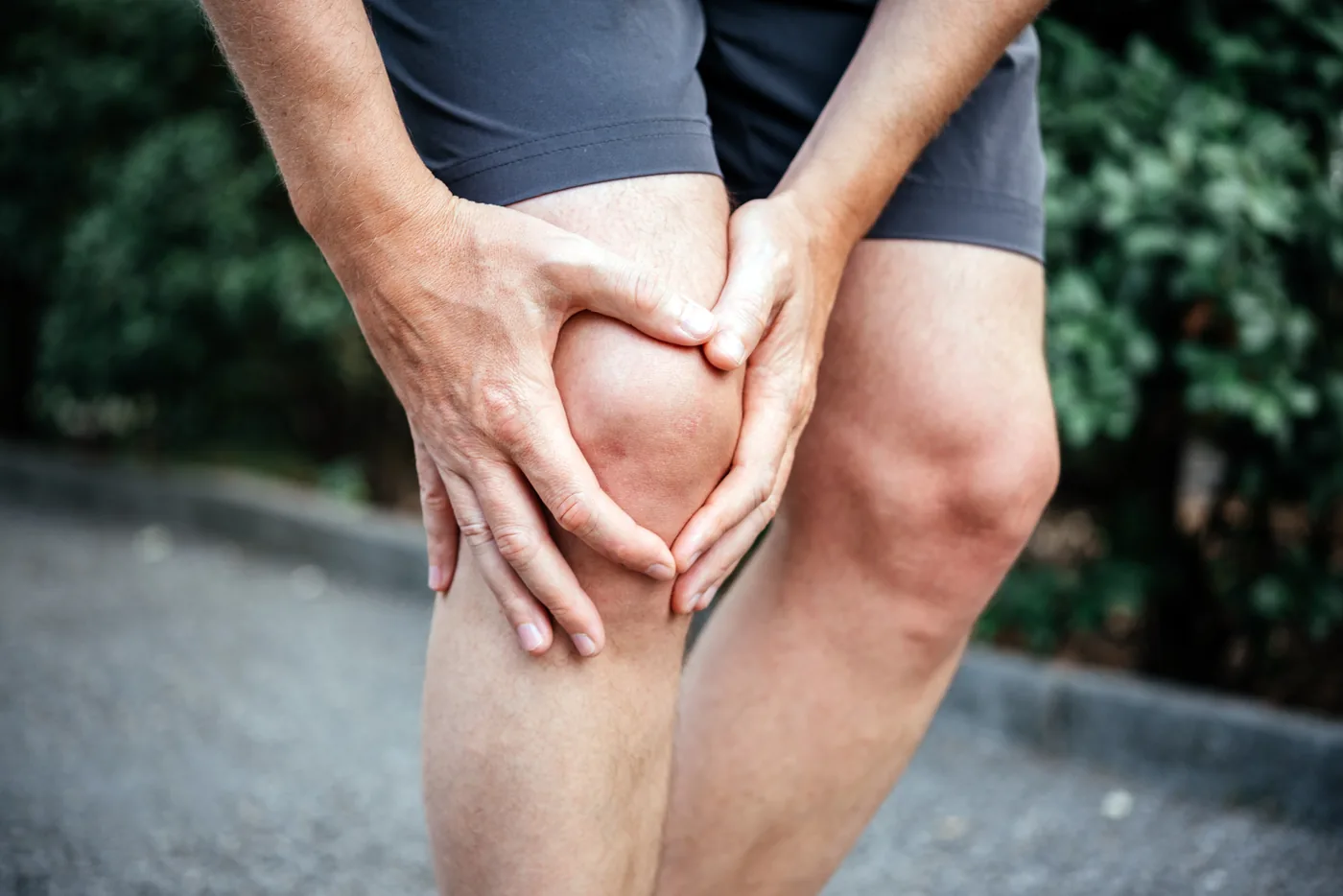 Athlete holding his knee in pain