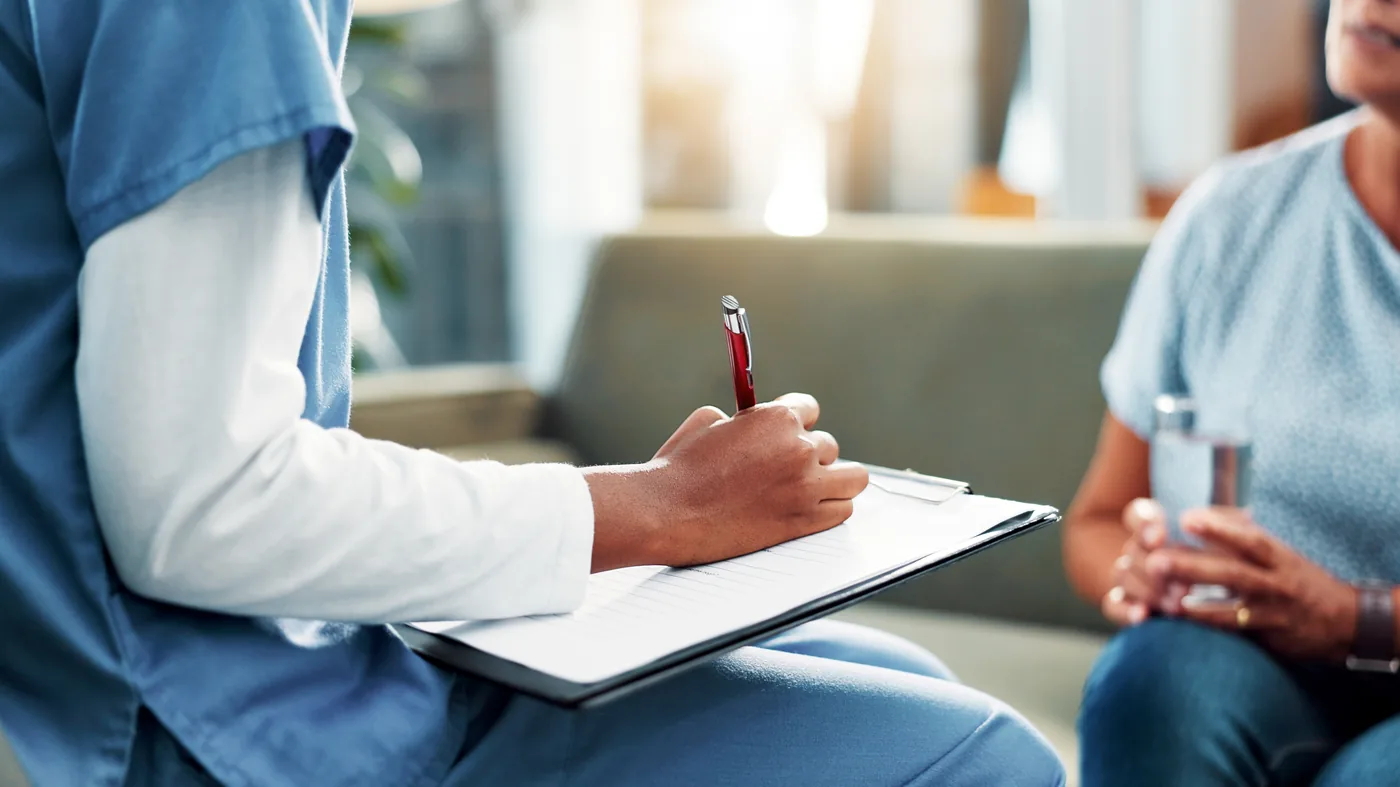 Health care team member reviewing paperwork with a patient